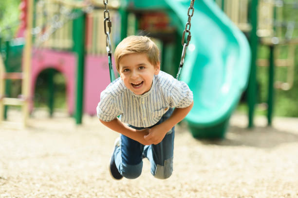 istock Baby boy having fun on a swing. 1438639020