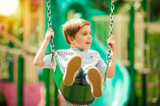 istock Baby boy having fun on a swing. 1438639056
