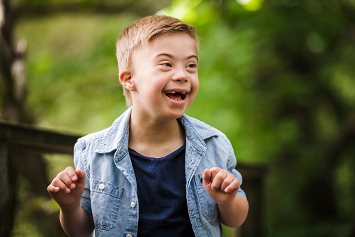 Close up portrait of a happy little boy looking at the camera and laughing