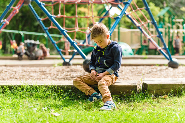 istock Portrait of a little boy with down syndrome while playing in a park 1438639366