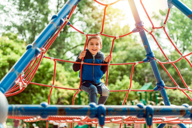 istock cute boy having fun on a playground 1438640009