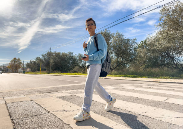 istock Student crossing the crosswalk 1438641348