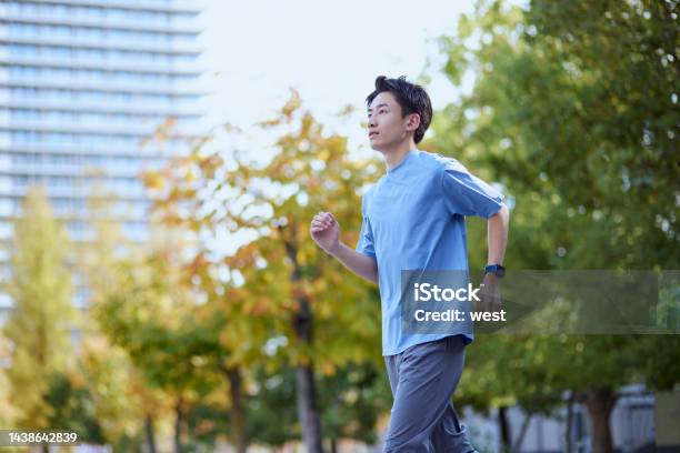 Young Japanese Man Wearing Sportswear Stock Photo - Download Image Now - Men, Only Men, Jogging