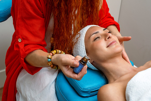Woman getting massage with relaxing and therapeutic essential massage oil
