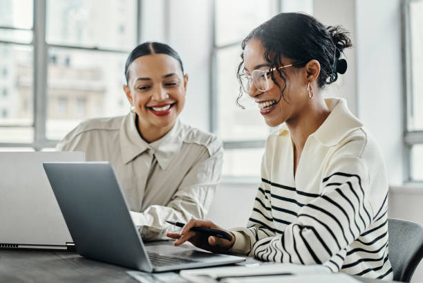 istock Business women, laptop and teamwork in startup office for data analysis team reading, laughing and talking while online. Female management employees working together kpi report, research and planning 1438644228