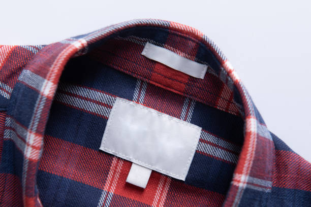 istock White blank clothing tag label on new shirt fabric texture background 1438645564