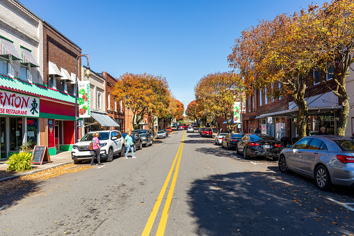 Galax, VA, USA-15 October 2022: Wide-angle view down Main Street on a sunny, autumn day. Two women talking.