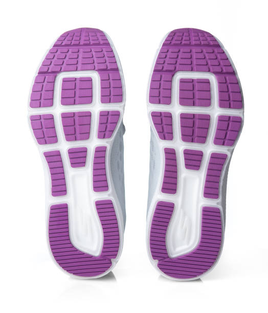 istock Running shoes with a purple white sole on a white background. Bottom view 1438647493
