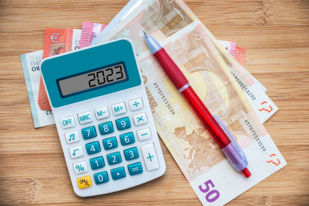 2023 numbers on a calculator and euros banknotes, new year finance, money inflation and budget concept stock photo
