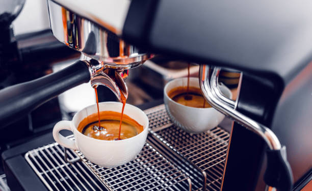 istock Coffee extraction from the coffee machine with a portafilter pouring coffee into a cup, Espresso pouring from coffee machine at the coffee shop 1438653635
