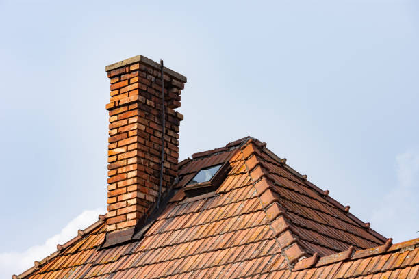istock Old house with window in roof and bricks chimney 1438653730
