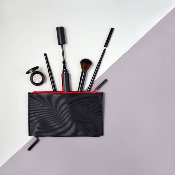 istock Make up products spilling out of a black cosmetics bag, with empty space at right side. 1438654906