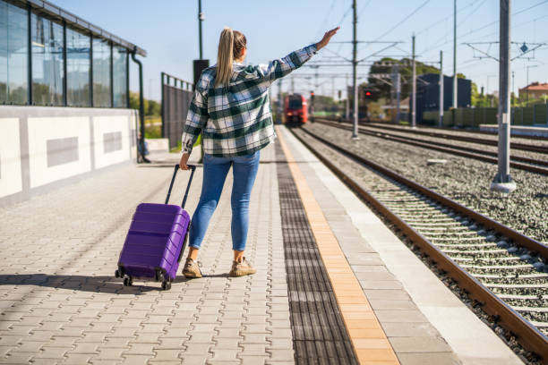 istock Woman waving on train station 1438659739