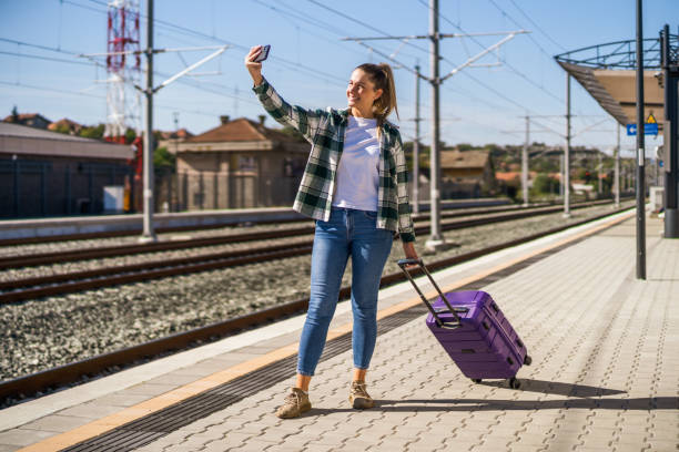 istock Woman taking selfie on a train station 1438659751