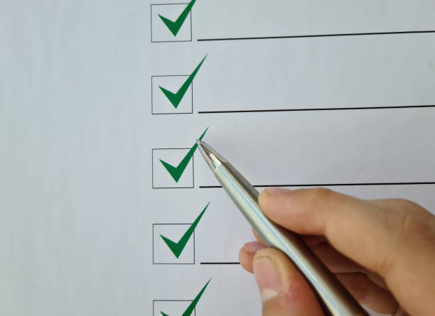 istock Silver ballpoint pen to cross off items from checklist 1438660225