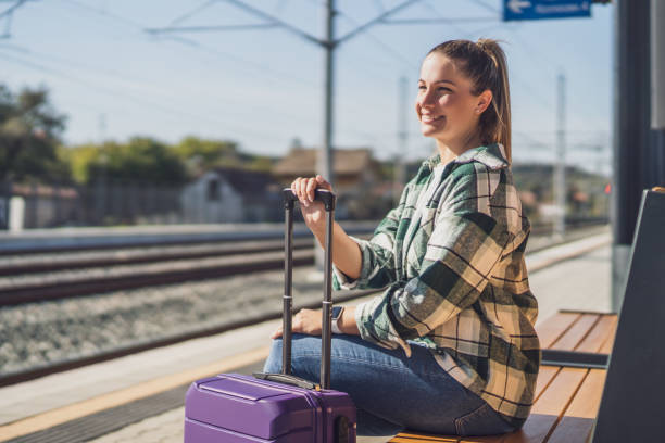 istock Woman  sitting on a bench at the train station 1438660232