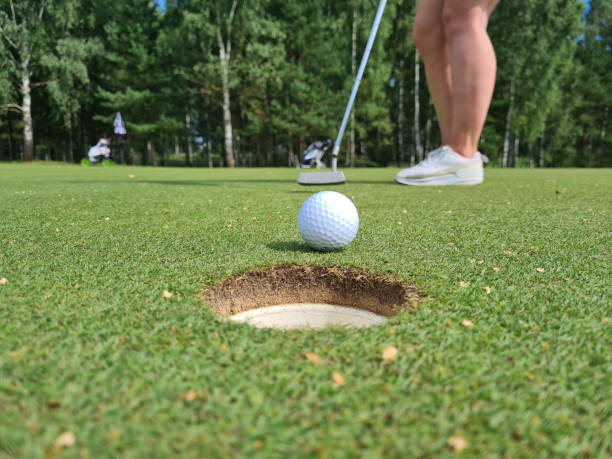 Golfer puts the ball on green golf closeup Golfer puts the ball on green golf. Golf ball on green about to be put in hole golfer swinging club stock pictures, royalty-free photos & images