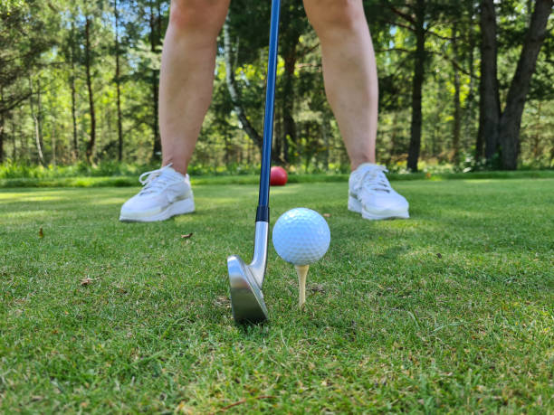 istock Closeup of golfer ready to tee off 1438660259