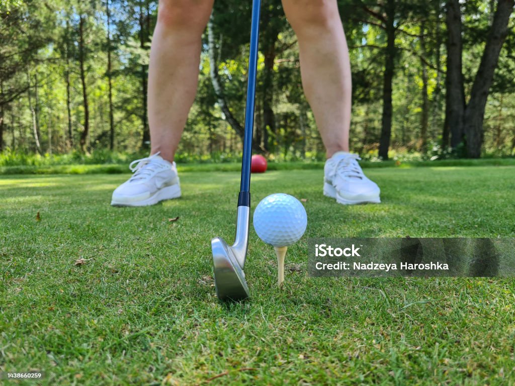 Closeup of golfer ready to tee off Closeup of golfer ready to tee off. Tee golf game Golf Swing Stock Photo