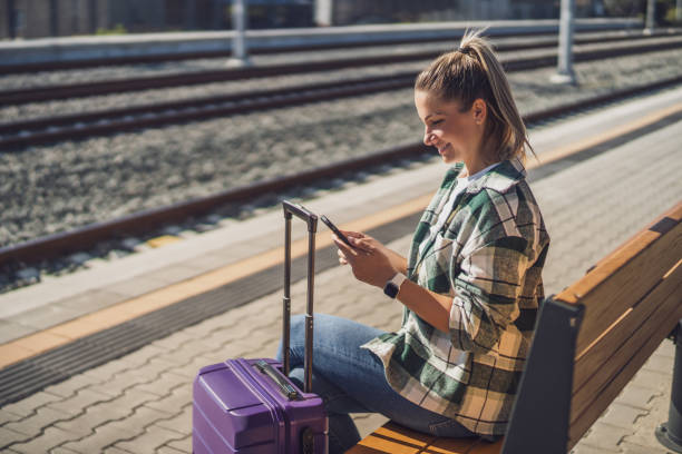 istock Woman using mobile phone on a train station 1438660285