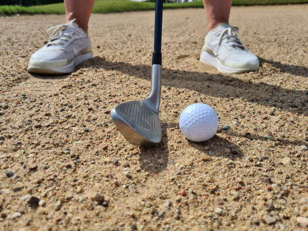 istock Golf shot from sand bunker golfer hitting ball from danger 1438660296