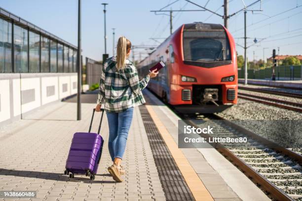 Woman Waiting To Enter Into The Train On Station Stock Photo - Download Image Now - Station, Railroad Station Platform, Train - Vehicle