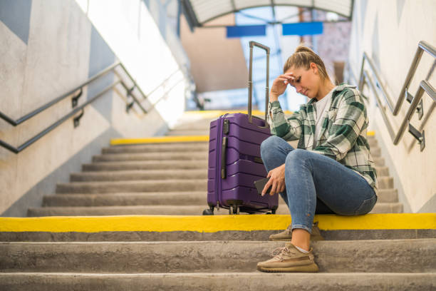 Worried woman  on a stairs  at the  train station stock photo