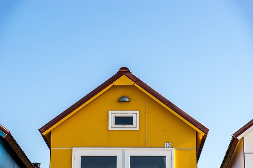 The yellow facade of a small house at the Camping De Nolle Vlissingen in the Netherlands