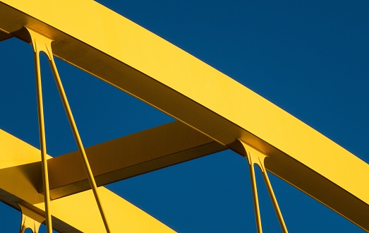 The fragments of a modern yellow construction with a blue background