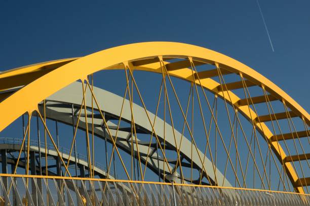 Fragments of a modern yellow and grey construction with a blue background