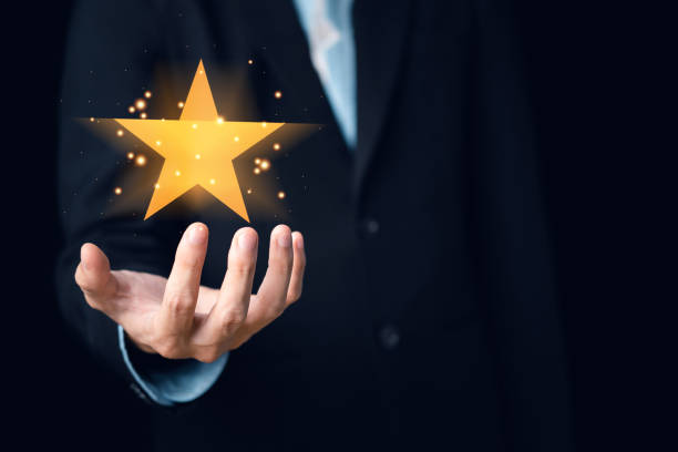 istock Businessman customer reviews. Star on hand. Customer service evaluation and satisfaction. Top service, ISO certification, Guarantee, Quality assurance, Standards concept. 1438663263