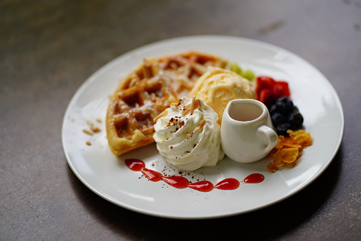 Homemade waffles with ice cream on white  plate