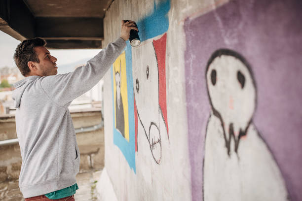 istock Artist painting graffiti on wall 1438668700