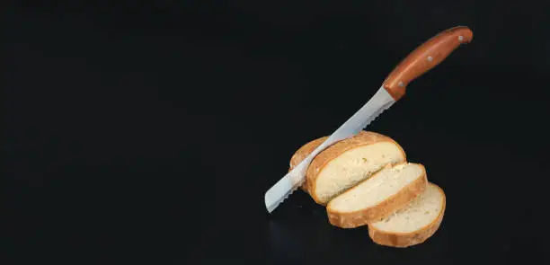 Seed bread, homemade bread,cutting bread. Close-up metal kitchen knife cuts bread on cutting board