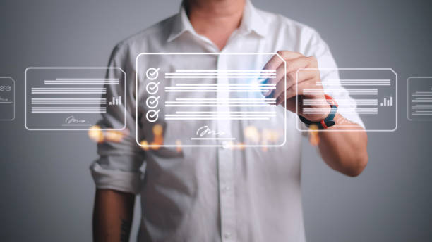 istock Paperless workplace ideas, e-signing, electronic signature, document management. A businessman signs an electronic document on a digital document on a virtual screen using a stylus pen. 1438674521
