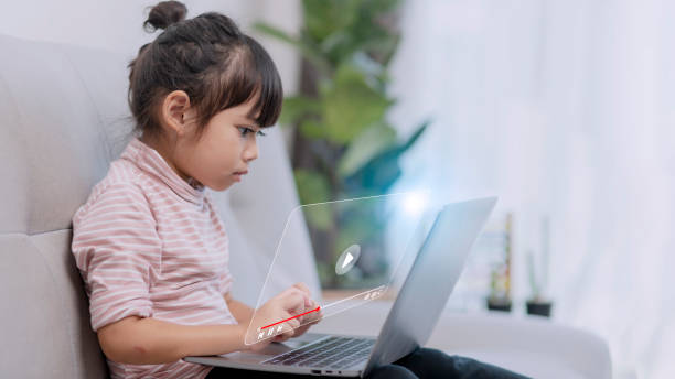 istock Asian little girl using the laptop. Internet of Things. EdTech. 1438674558