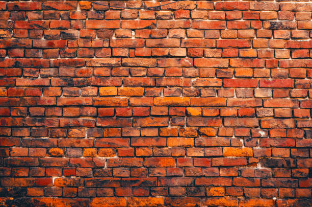 istock Vintage orange brick wall. Brickwork with cracks. Abstract background. 1438675492