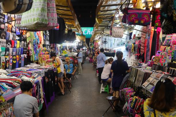 Shoppers browse the various stores at the Patpong night market. This is a popular tourist attraction Bangkok, Thailand – March 27, 2020: Shoppers browse the various stores at the Patpong night market. This is a popular tourist attraction in the city. silom stock pictures, royalty-free photos & images