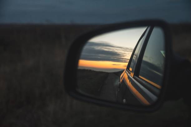 reflection of the beautiful sunset through the car's wing mirror - night reflection window vehicle door imagens e fotografias de stock