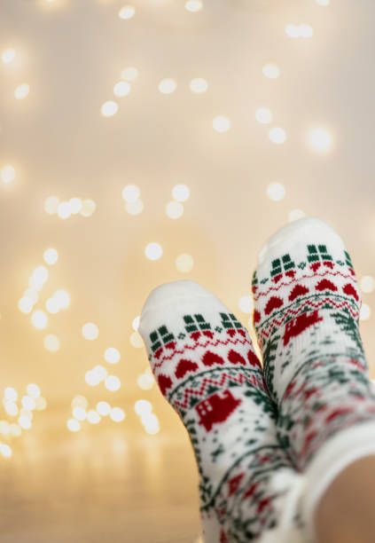 istock Woman feet with Christmas socks. 1438676770
