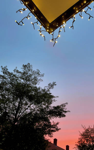 istock Christmas lights with setting sun in the city 1438676822