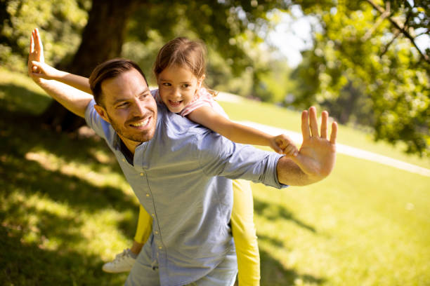 istock Father with daughter having fun at the park 1438678185