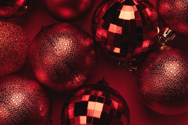 istock Christmas card with red balls on red background 1438678340