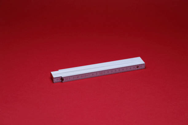 istock white wooden ruler on the red background 1438679993