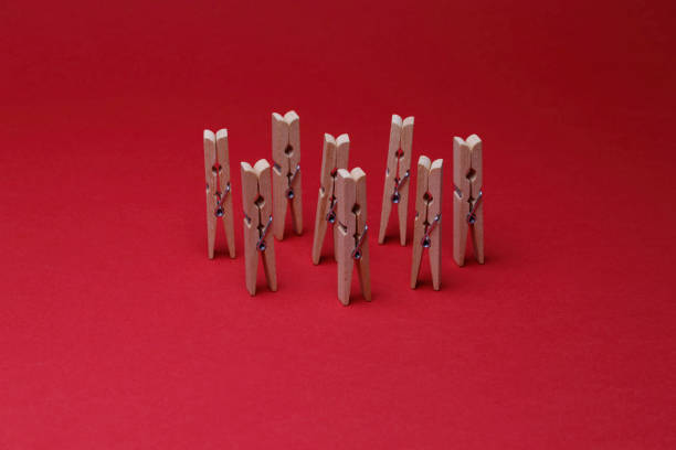 wooden clothes pegs on the red background