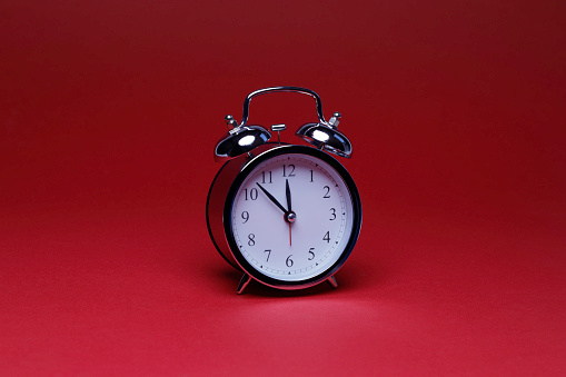 alarm clock on the red background