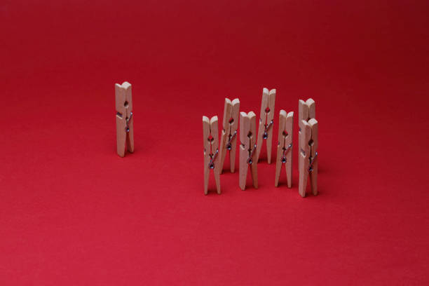 istock wooden clothes pegs on the red background 1438680723
