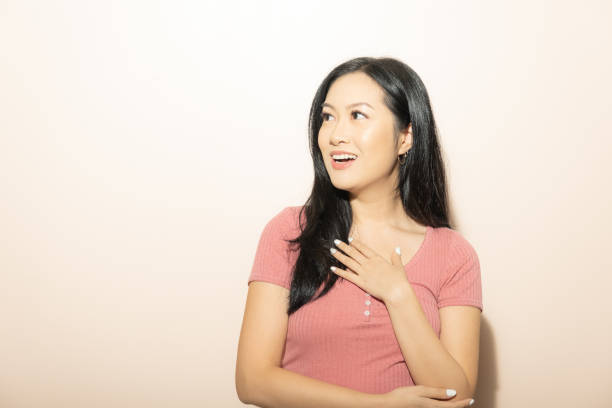 istock Surprised Attractive Young Asian Chinese Woman on Neutral Backdrop 1438681219