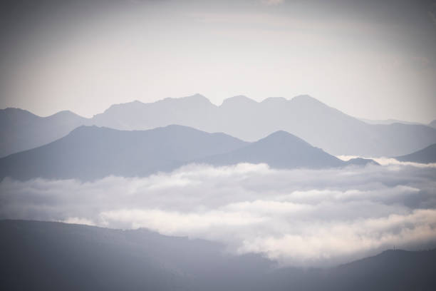 rocky mountain ridges at sunset with fog in León, Castile and León, Spain