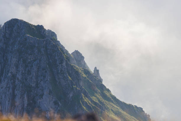 rocky mountain ridges at sunset with fog in León, Castile and León, Spain